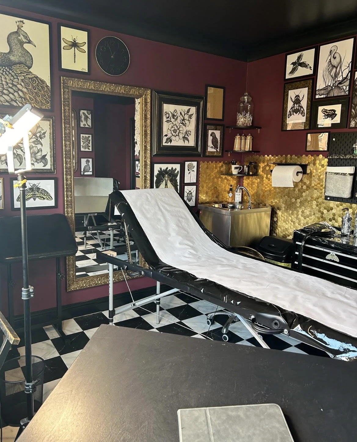 Eleanor’s private tattoo studio, with framed artwork and a treatment chair